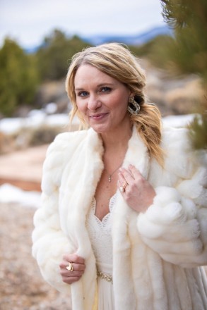 Bride, Linsey, with with pinon trees, snow, and mountains in Questa