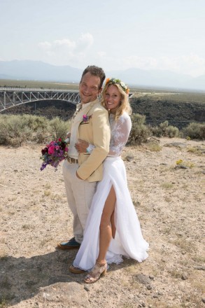 Wedding couple, Daniela and Eric, newly married at the Gorge Bridge in Taos, NM