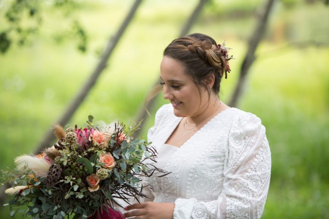 Scarlett admires her bouquet with a spring green meadow background