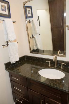 Single sink with granite counter and dark cabinets in Taos skier condo