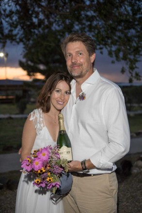 Erin and Cory after their destination elopement at Rio Grande Gorge Bridge with local champagne