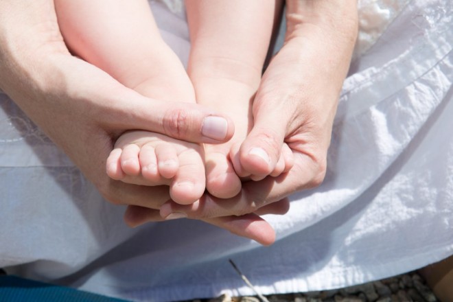 Documenting a wedding by capturing mommy's hands and baby's feet.