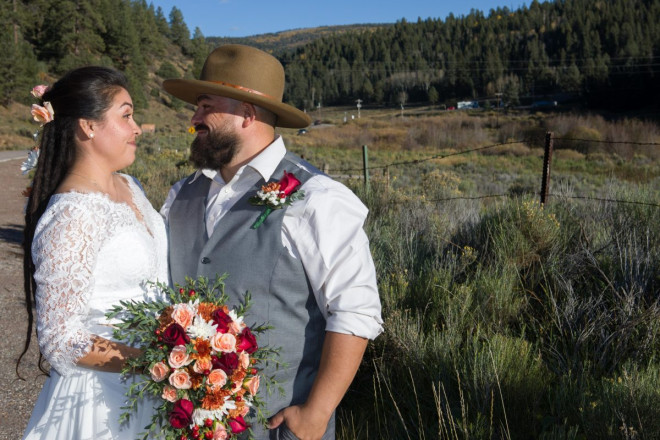 Sarah and Edwardo smile in autumn mountain landscape