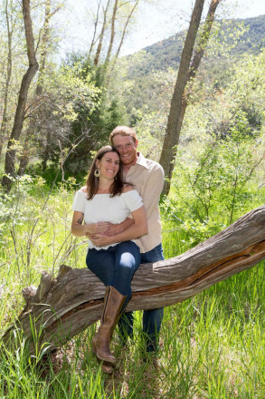 Early spring engagement shoot with mountains and spring green grass