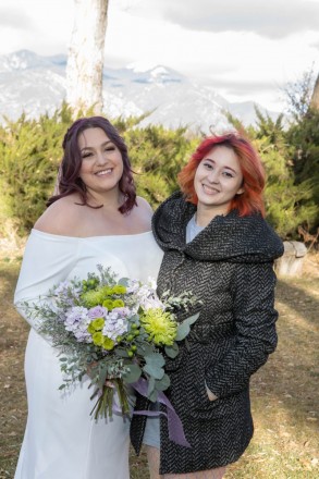 The bride and her best friend in front of Taos Mountain.
