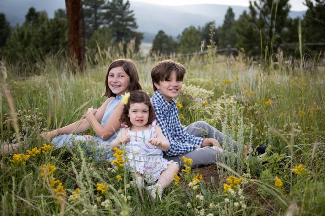 Angel Fire family photographs during fire season with smoky mountains and wildflowers
