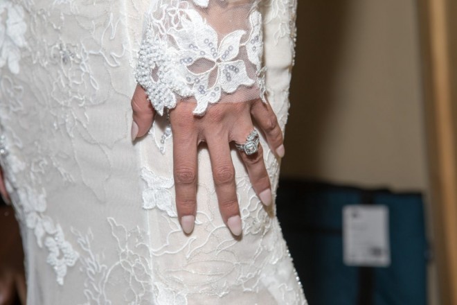 Diamond wedding ring, perfect nails, and wedding dress detail