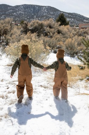 Brothers walk through the January Taos snow with matching Carhart outfits