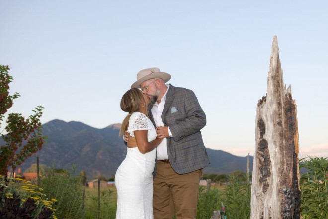 Bre and James kiss in front of sacred Taos mountain