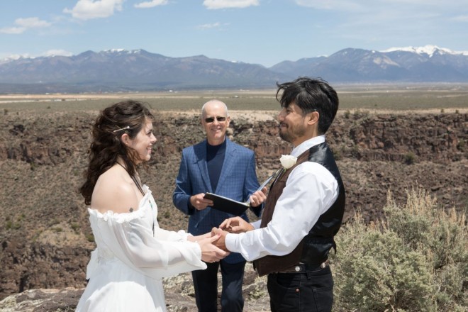 Mackenzie and Steven exchange rings as they joke about them falling over the edge during their cliff-side wedding ceremony