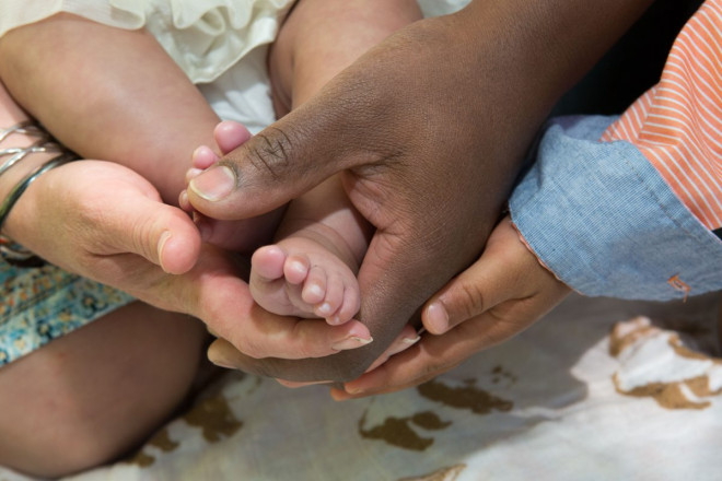 Family holds hands for photo detail shot during their family portraits