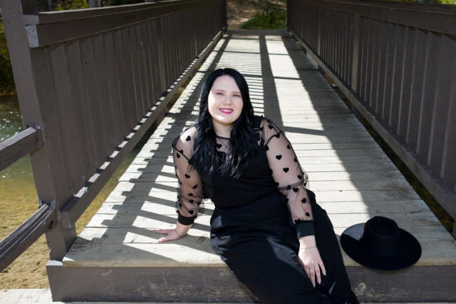 Class of 2023 graduate smiles for professional senior portraits