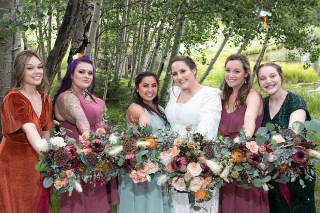 Airy professional bouquets by Enchanted Florist with bridesmaids in front of aspen trees