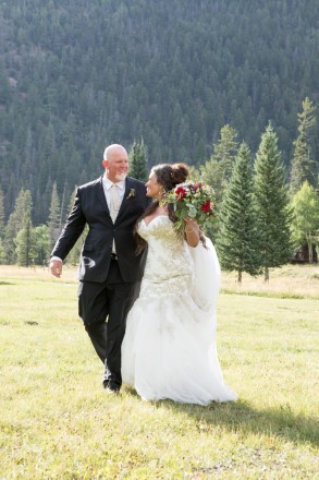 Catrina and Jackie walk together to their cabin after their Red River NM elopement