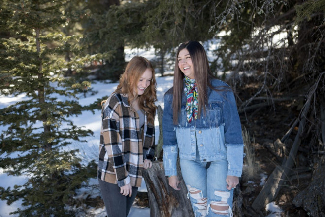 Senior friends crack up in laughter during their joint-senior session in Angel Fire