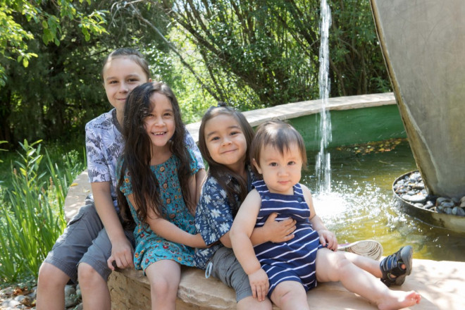Four smiling siblings have their pictures taken in Arroyo Seco, NM