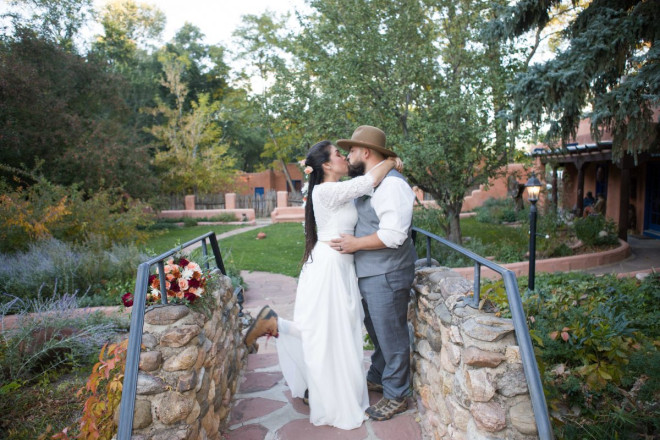 Beautiful hippie couple adorned in wedding outfits and hiking boots