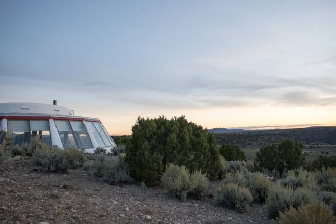 Earthship home with windows looking at Three Peaks in Taos, NM