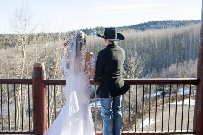 Wind in Angel Fire subtly blows bride's hair and groom's jacket