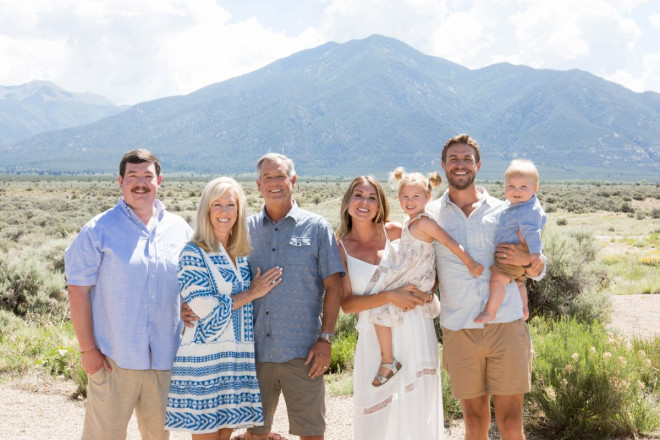 Taos mountain poses for portaits with family on the north side of Taos