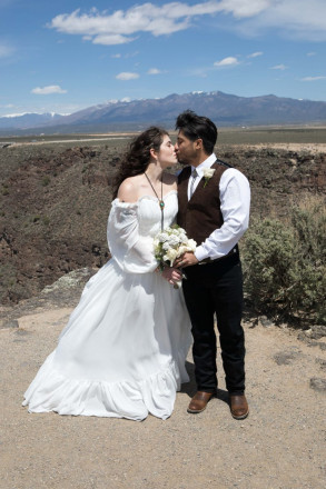 Mackenzie wears a bolo tie with her off-the-shoulder wedding dress