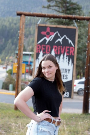 High school senior takes advantage of fun backgrounds on Main Street in Red River