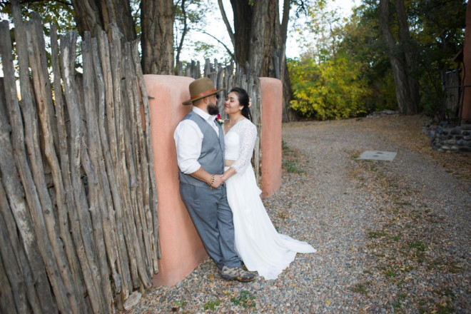 Latilla fencing, adobe walls, cottonwood trees and yellow leaves