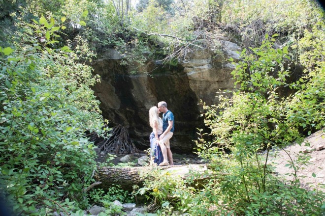 Deanna and Wyatt kiss for an engagement photo in front of the Ice Cave
