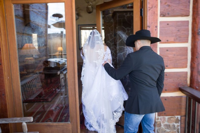 Groom carried bride's dress into their log cabin in Angel Fire, NM