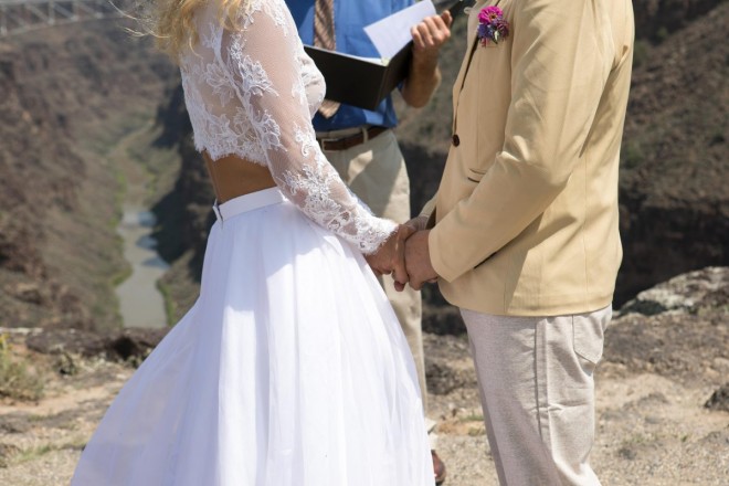 Daniela and Eric hold hands as Dan Jones officiates the wedding elopement ceremony