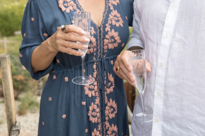 Susan wore a blue dress with pink embroidery while JR wore a white linen button-down shirt