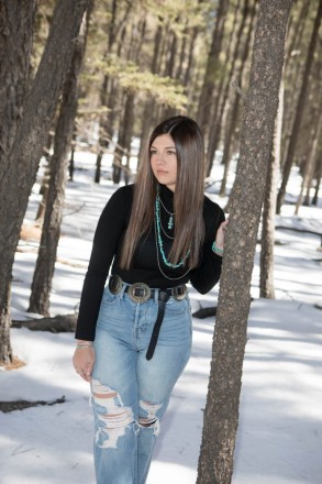 Class of 2022 senior with shiny long hair and turquoise jewelry in Angel Fire, NM