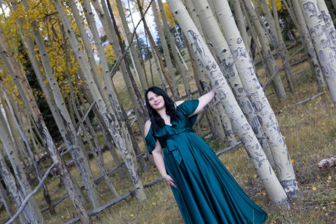 Senior girl poses for portraits with the aspen trees in a formal dress