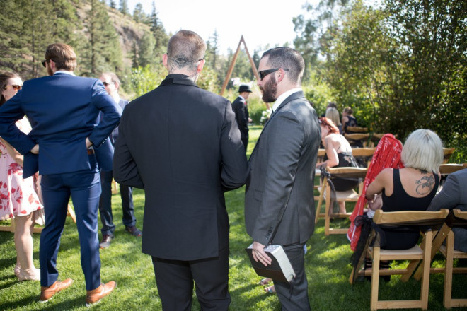 Groom, Travis, and minister talk before the ceremony about wedding details