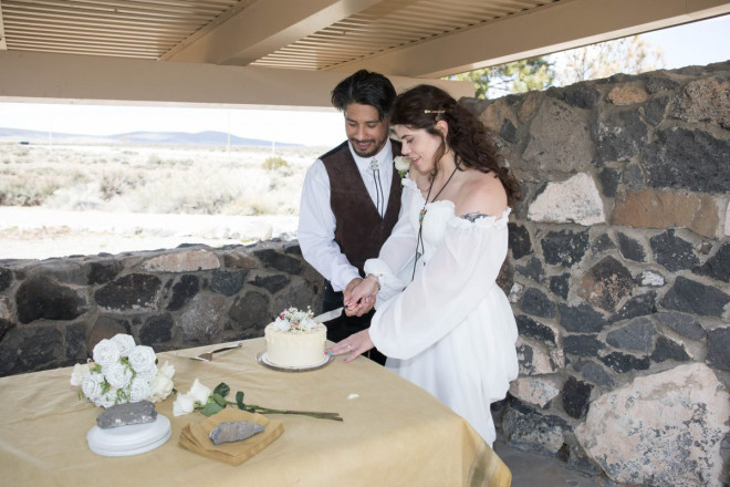 Mackenzie and Steven cut the wedding cake together