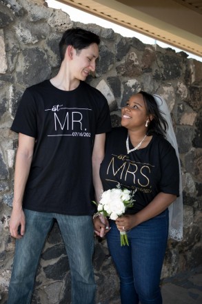 Bride and groom change into Mr. and Mrs. t-shirts after wedding