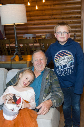 Grandpa and his flower girl and ring bearer grandchildren, unwind after the wedding