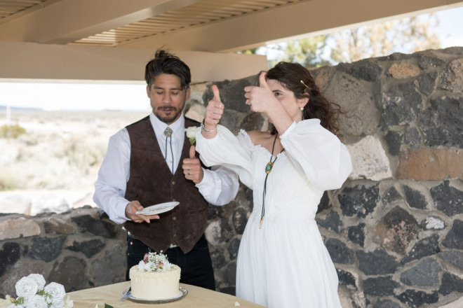 Mackenzie gives two thumbs up to the exquisite wedding cake that comes with Dan Jones' wedding package