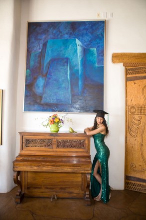 High school senior poses in green gown by gorgeous Taos art scene