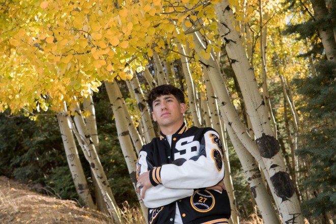 Jacob stand proudly with his high school Letterman jacket in Red River, NM