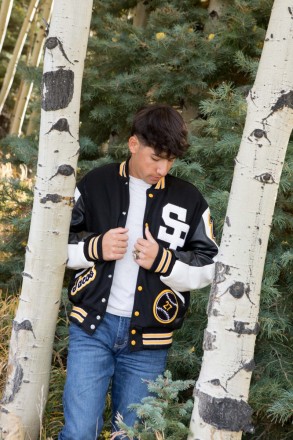 The conifer and aspen trees make a perfect frame for Jacob's senior photo shoot