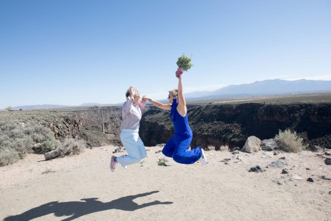Jeannie and Debbie jump in the air with excitement of their new marriage