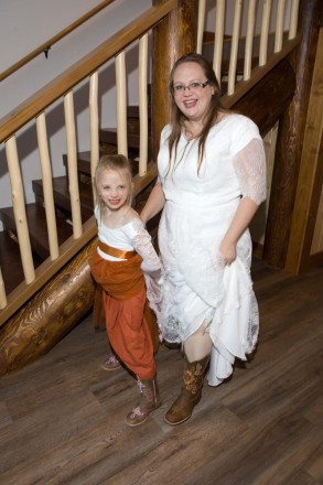 The bride and flower girl show off their customized wedding boots
