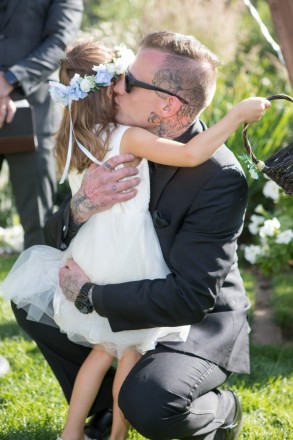 Groom, Travis, kisses his flower girl and niece before the wedding ceremony begins.