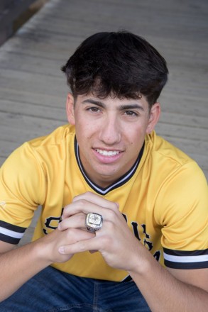 Jacob shows off his all-stars Baseball ring during his senior pictures in Red River