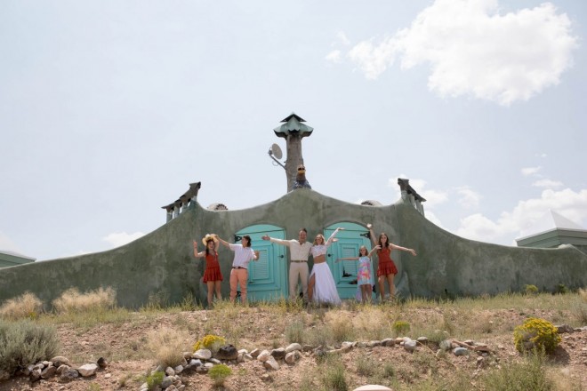 Daniela and Eric pose with their Taos Earthship on Wedding Day