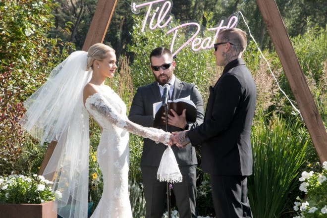 The multi-layered veil and slim dress was the perfect ensemble for Courtney. Travis wore an all black tux.