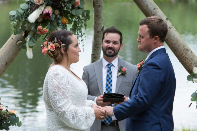 Scarlet and Clynt hold hands while they share their wedding vows