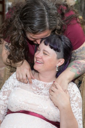 Two brides, Kelsey and April, in pure bliss after a beautiful evening wedding ceremony