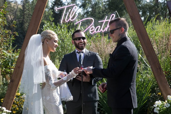 Courtney puts a candy ring on Travis' finger during their South Fork wedding ceremony
